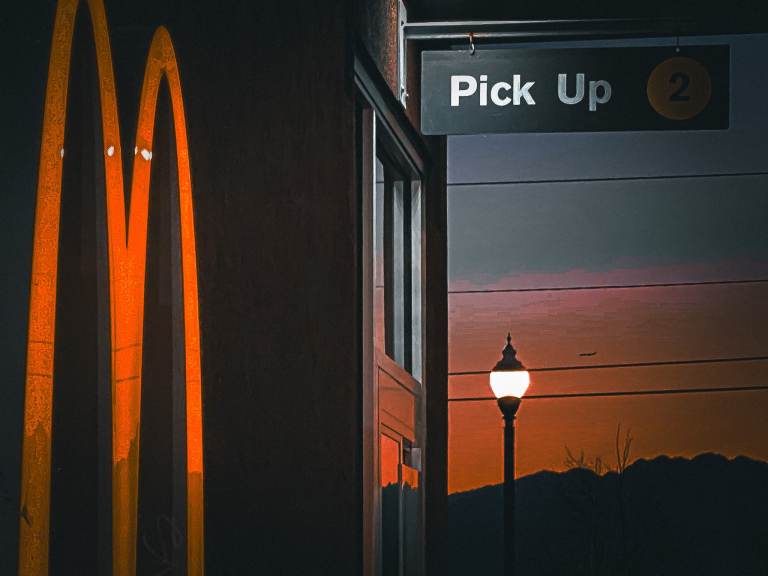 A poetry workshop around the poem "Diet Go Round." Glowing arches with the early morning sunrise in the background.
