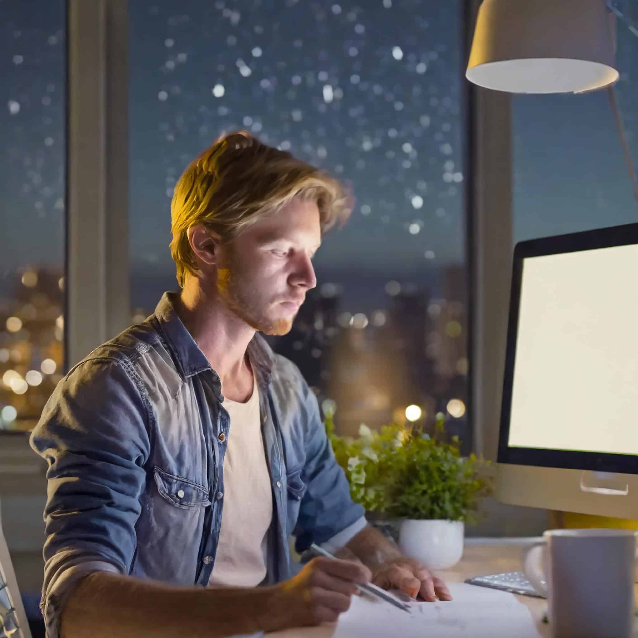 Writer contemplating under the night sky with a blank screen, seeking inspiration.