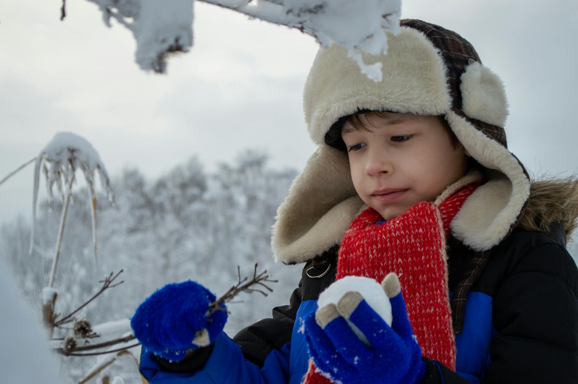 kid holding a snow ball