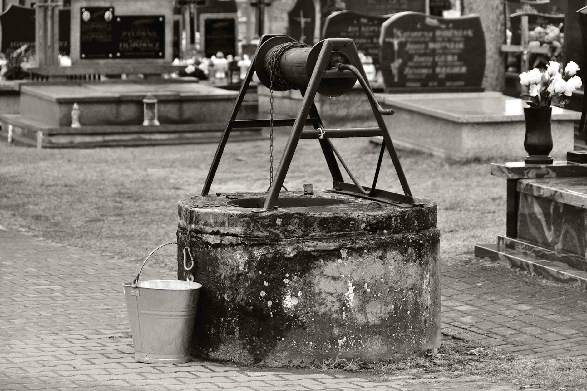grayscale photo of water well