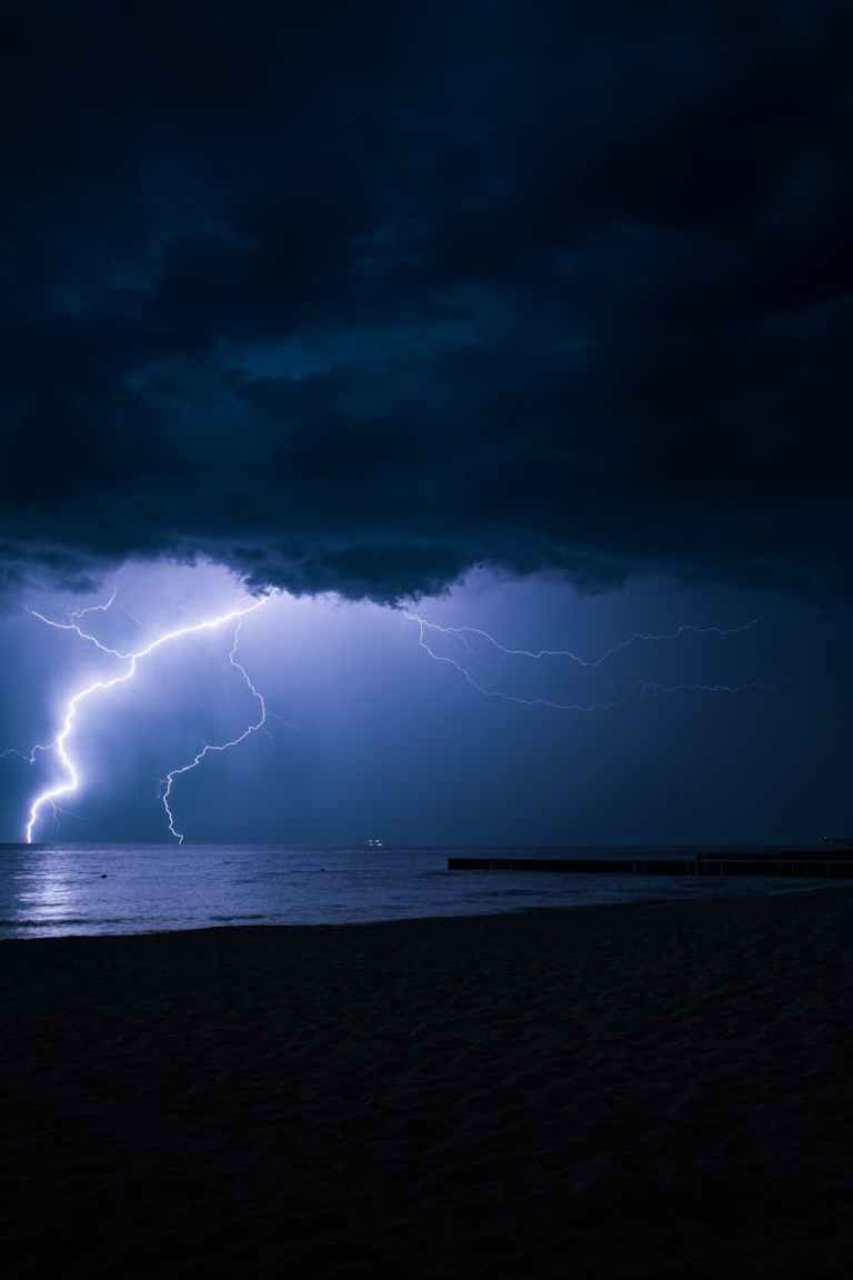 a lightning strike across the night sky