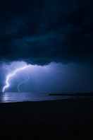 a lightning strike across the night sky