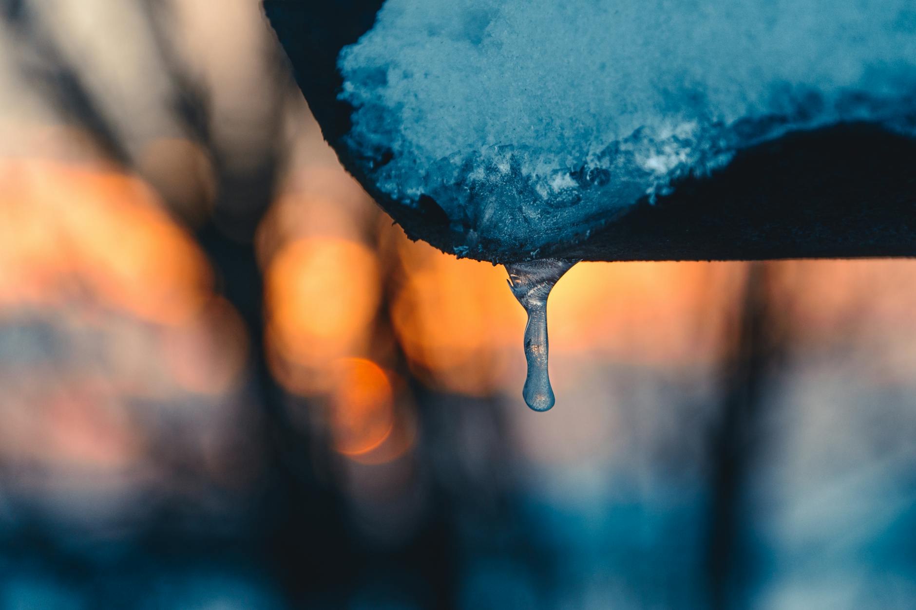 selective focus photography of blue dripping water